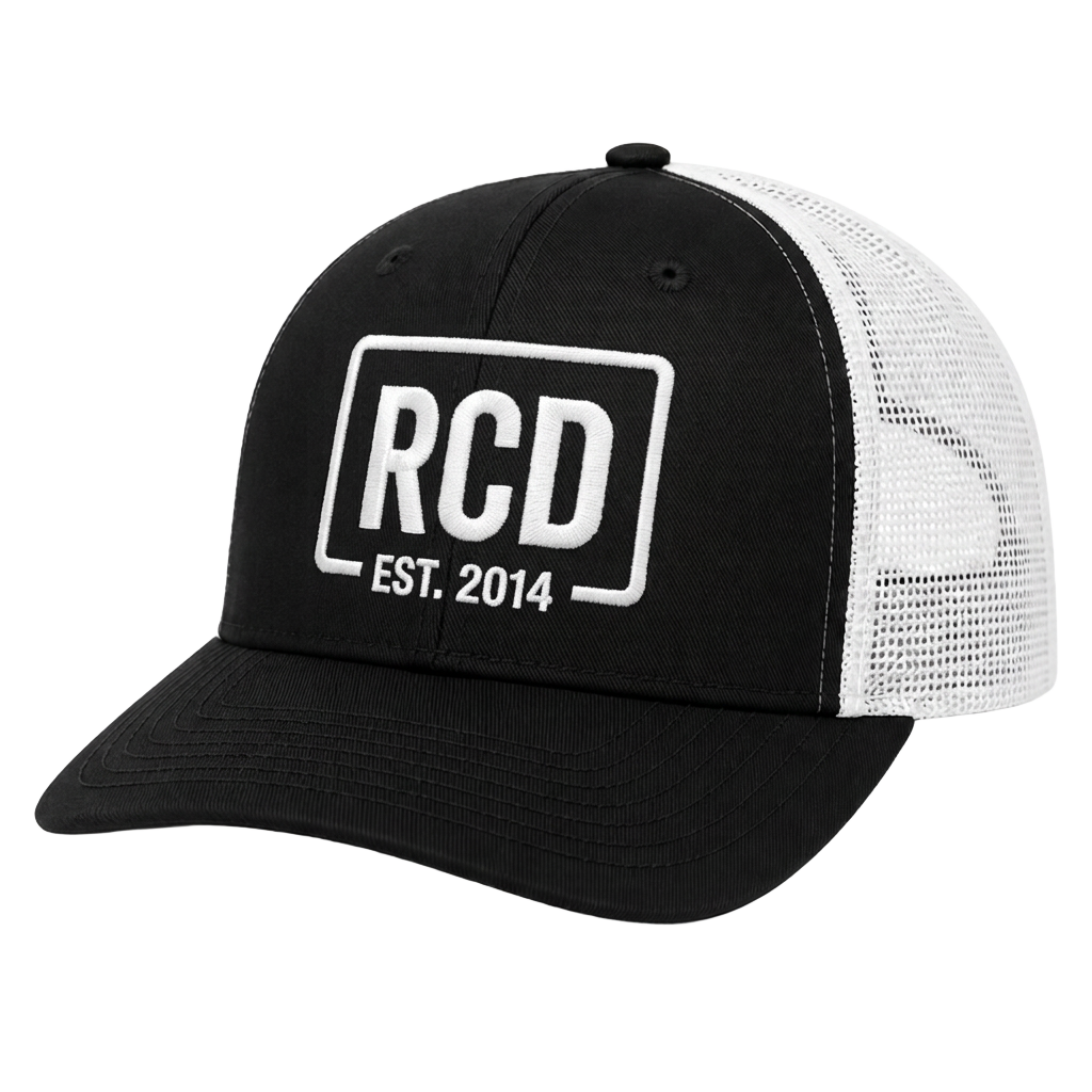 Black and white trucker hat with an embroidered RCD patch