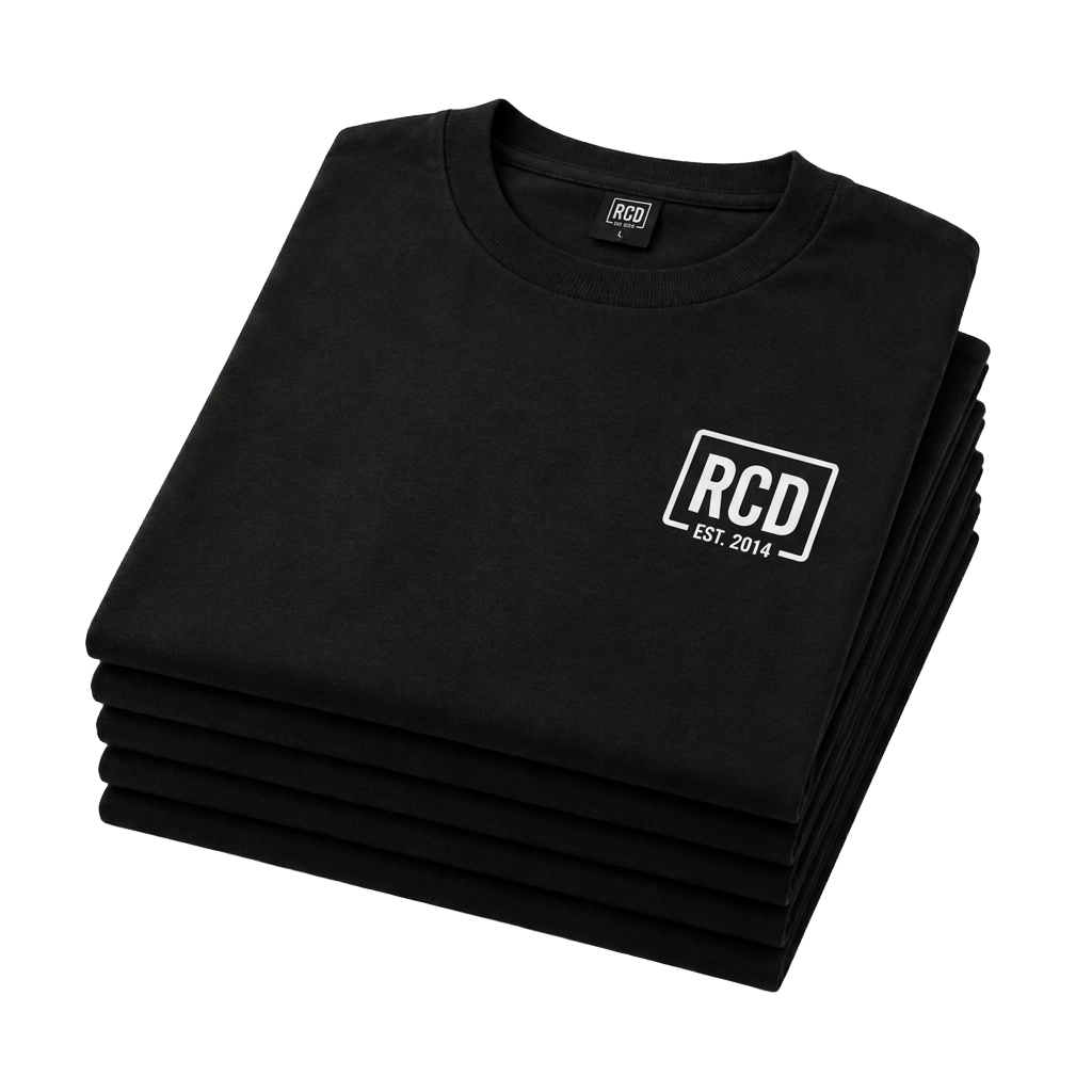 Stack of black screen-printed RCD t-shirts